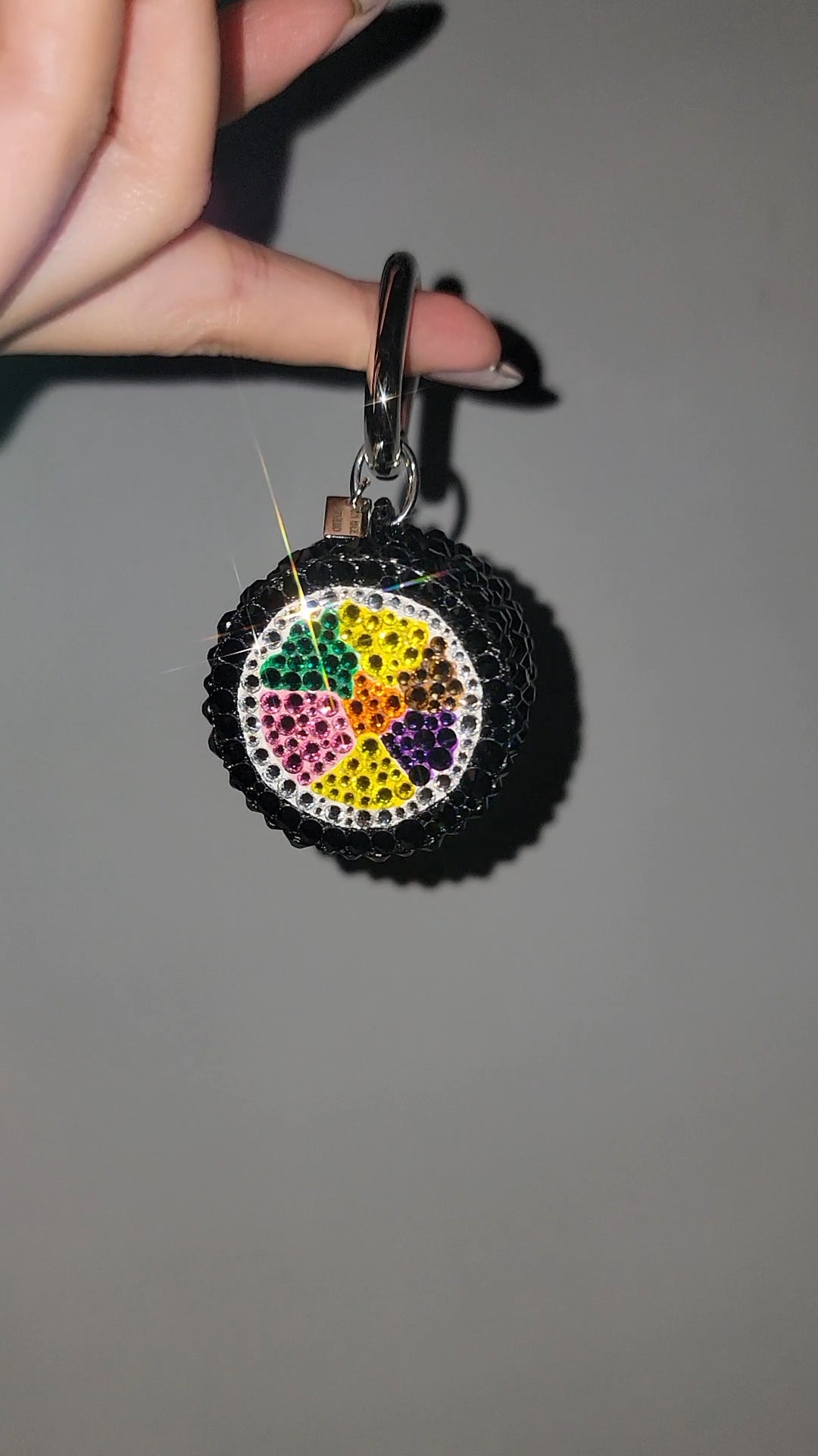 Front of Gimbap Slice Bag Charm against a gray wall