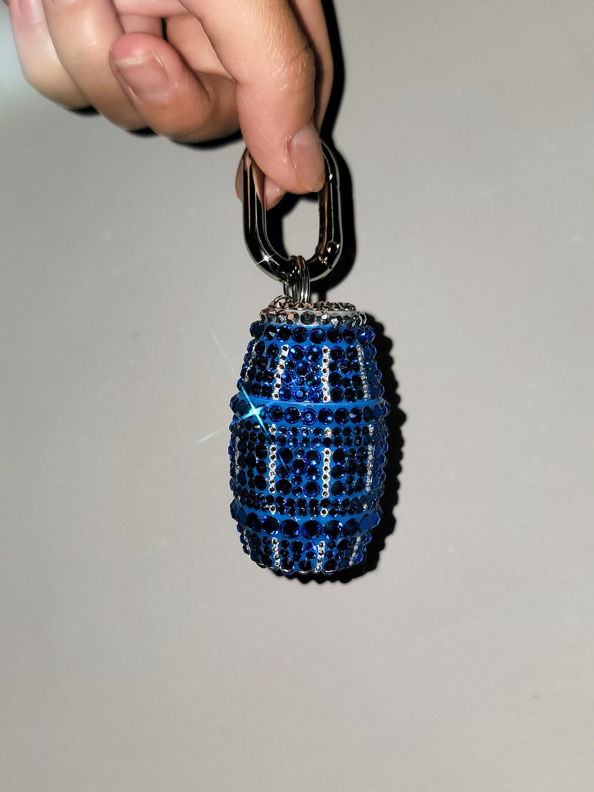 Front picture of Blue Quarter Water Bag Charm with a gray background.