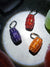 Picture of three quarter waters lying flat on the ground: orange, red, purple.