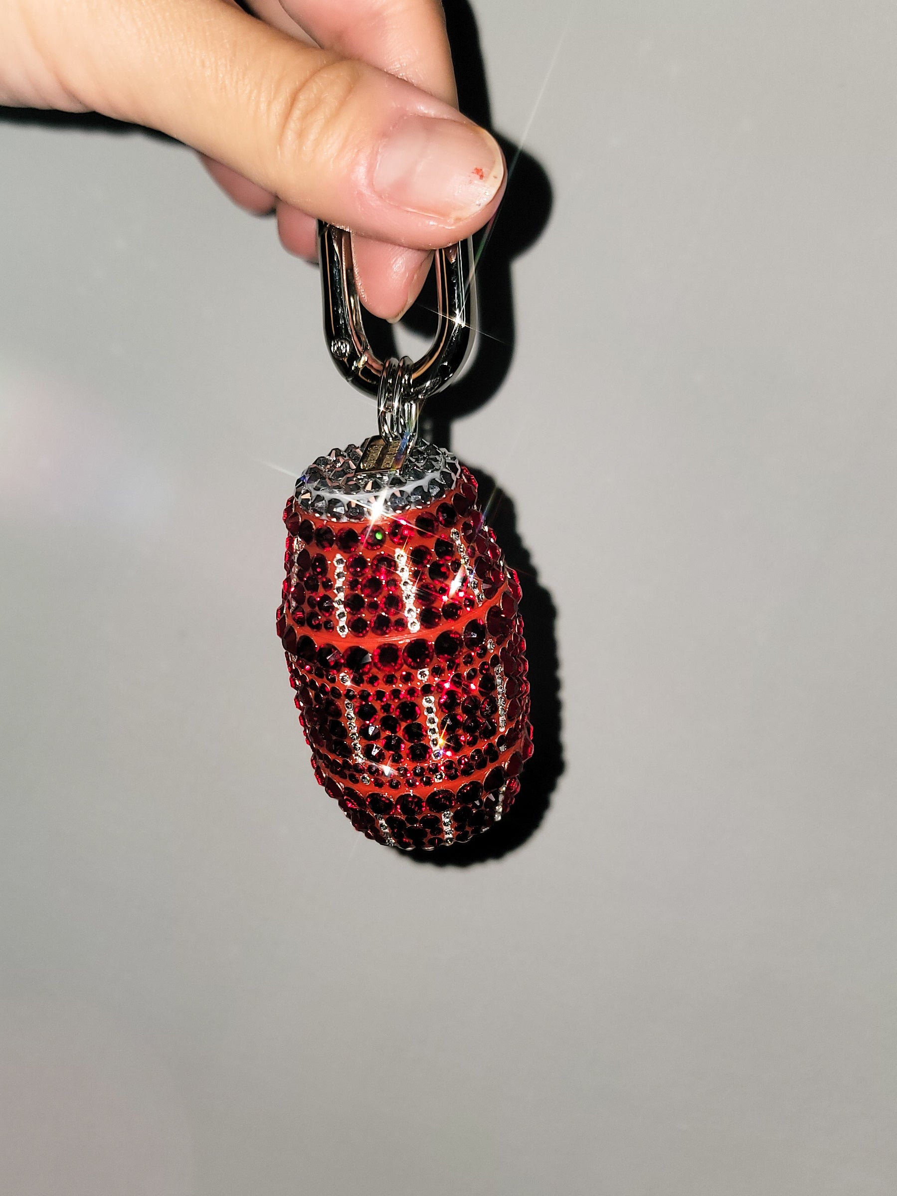 Front picture of Red Quarter Water Bag Charm with a gray background.