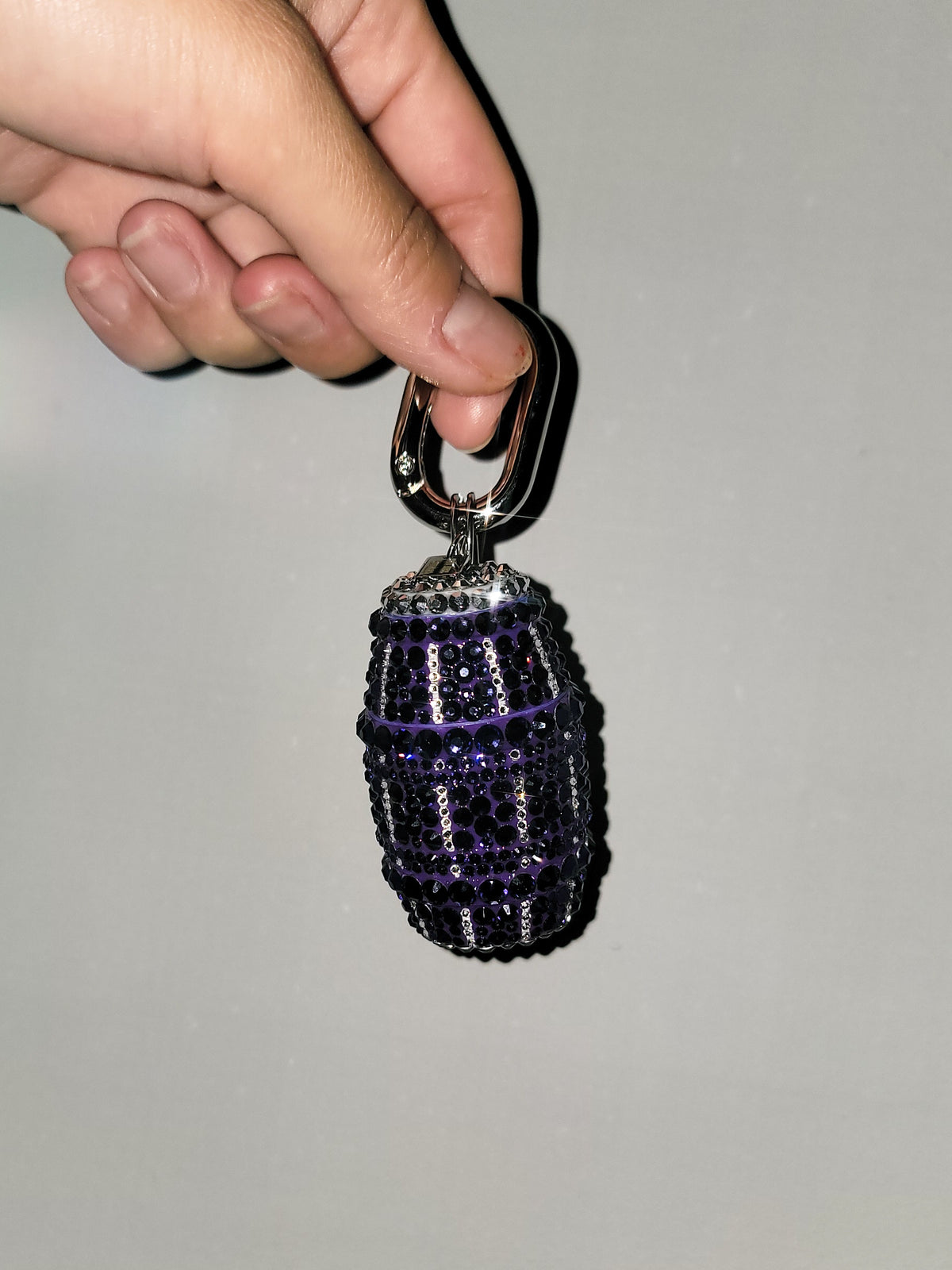 Front picture of Purple Quarter Water Bag Charm with a gray background.