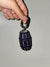 Front picture of Purple Quarter Water Bag Charm with a gray background.