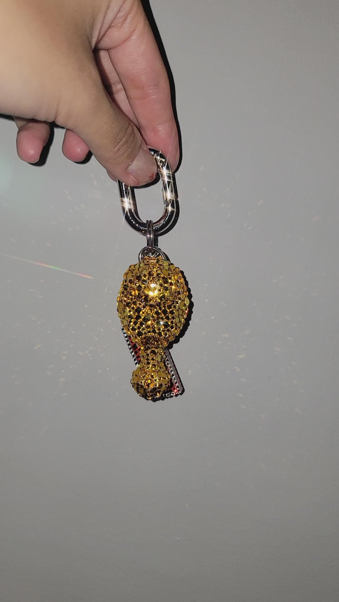 Video of Drumz Bag Charm being rotated against a gray background.