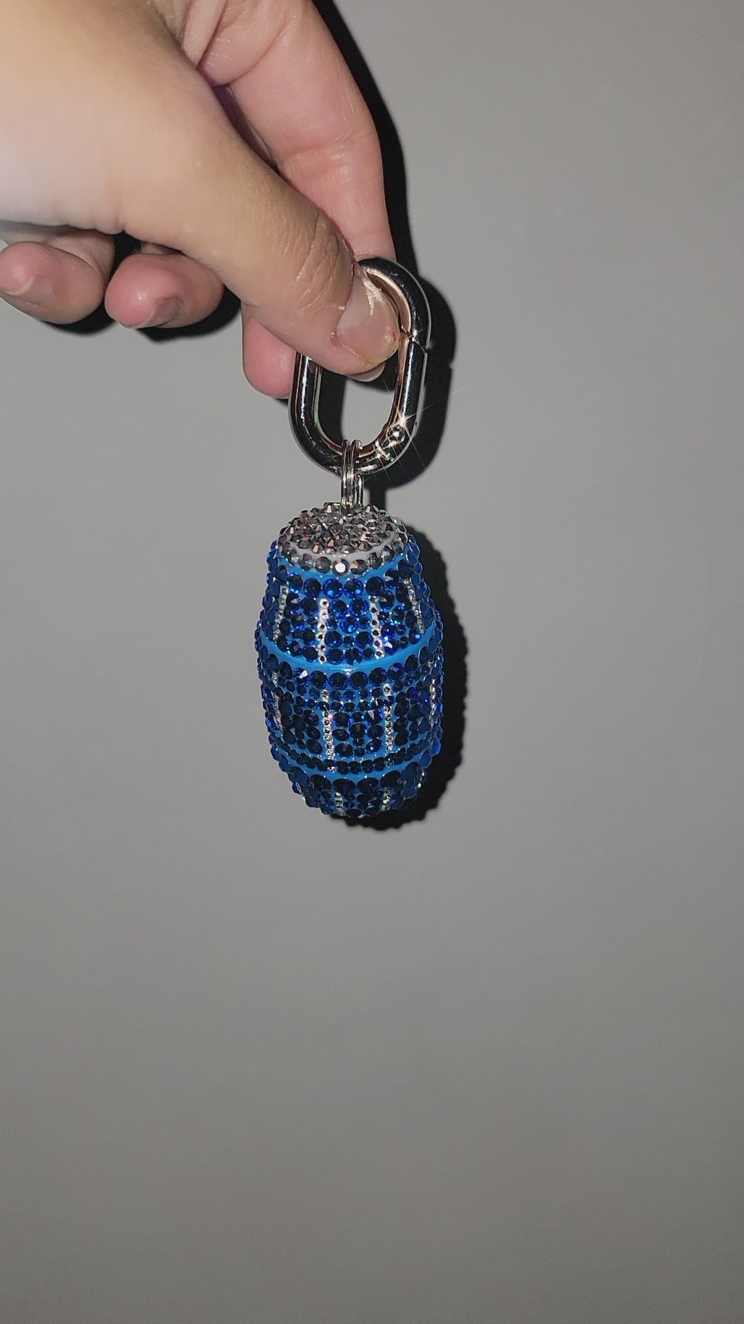 Video of Blue Quarter Water Bag Charm being held up against a gray background.